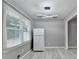 Kitchen area featuring modern lighting fixture, a refrigerator, and a window providing plenty of natural light at 1094 Amber Sw Rdg, Lilburn, GA 30047