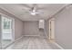 Open-concept living room featuring updated flooring and access to the screened-in porch and stairs at 1094 Amber Sw Rdg, Lilburn, GA 30047
