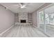 Living room featuring built-in shelving around the fireplace, natural light, and wood-look flooring at 1094 Amber Sw Rdg, Lilburn, GA 30047