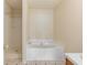 A clean bathroom with a shower and a separate tub for a relaxing bathing experience at 131 Tye St, Stockbridge, GA 30281