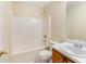 Bathroom featuring a tub/shower combo, white tile, vanity with sink and a mirrored medicine cabinet at 131 Tye St, Stockbridge, GA 30281