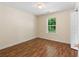 Bright bedroom featuring hardwood floors, a window with natural light, and a fresh coat of paint at 131 Tye St, Stockbridge, GA 30281