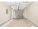 Spacious garage with concrete floors, neutral paint and an electrical panel box at 131 Tye St, Stockbridge, GA 30281