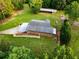 Aerial view features the house, barn, and lush landscaping of the property at 360 Parr Farm Rd, Covington, GA 30016