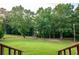Expansive backyard with lush green grass, framed by mature trees, as seen from the porch at 360 Parr Farm Rd, Covington, GA 30016