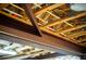 View of the exposed wooden beams, wiring, and metal supports in the basement ceiling at 360 Parr Farm Rd, Covington, GA 30016