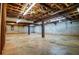 Unfinished basement with concrete floor, exposed wood beams and metal supports, offers ample storage space at 360 Parr Farm Rd, Covington, GA 30016