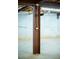 Basement with steel support beams and visible electrical outlets against a concrete wall at 360 Parr Farm Rd, Covington, GA 30016