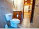 A tiled bathroom features a toilet, sink, and vanity with storage beneath at 360 Parr Farm Rd, Covington, GA 30016