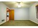 A carpeted bedroom with a ceiling fan is brightened by natural light from a window at 360 Parr Farm Rd, Covington, GA 30016