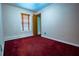 A bedroom features wall-to-wall carpet and a wooden-blinded window for natural light at 360 Parr Farm Rd, Covington, GA 30016