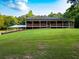 Charming ranch-style home featuring a full, spacious porch with wooden railings and a large grassy front yard at 360 Parr Farm Rd, Covington, GA 30016