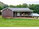 Brick home featuring a cozy covered porch and an adjacent carport at 360 Parr Farm Rd, Covington, GA 30016