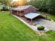 Wide angle view of a brick home with a carport, a spacious front yard, and mature trees in the background at 360 Parr Farm Rd, Covington, GA 30016