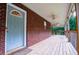 View of the spacious front porch with brick accents and ceiling fans at 360 Parr Farm Rd, Covington, GA 30016