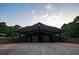 A detached garage with a metal covering and multiple doors set in a partially enclosed structure at 360 Parr Farm Rd, Covington, GA 30016