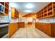 Spacious kitchen with wood cabinets and tile floors at 360 Parr Farm Rd, Covington, GA 30016