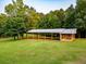 A covered outbuilding provides outdoor space on an expansive green lawn at 360 Parr Farm Rd, Covington, GA 30016
