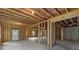 Unfinished basement with exterior door, wood framing, and natural light at 6120 Hutchins Dr, Buford, GA 30518