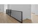 Hallway with black railing and wood floor at 6120 Hutchins Dr, Buford, GA 30518