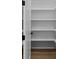 Bright pantry featuring ample shelving with a wooden floor and white walls at 6120 Hutchins Dr, Buford, GA 30518