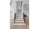 Elegant staircase with wooden treads and black metal railings in a modern open-concept home at 6120 Hutchins Dr, Buford, GA 30518