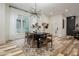 Inviting dining room with a modern chandelier, dark wood table, and bright natural light at 1168 Mado Loop, Chattahoochee Hills, GA 30268