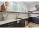 Bright kitchen with floating shelves, stylish countertops, and stainless steel appliances at 1168 Mado Loop, Chattahoochee Hills, GA 30268