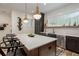 Kitchen with oversized island, pendant lights, stainless steel dishwasher, and wooden accents at 1168 Mado Loop, Chattahoochee Hills, GA 30268