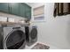 Laundry room featuring side-by-side washer and dryer with overhead cabinetry and storage at 1168 Mado Loop, Chattahoochee Hills, GA 30268