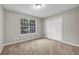 Cozy bedroom with neutral walls, carpet, a closet and large window with natural light at 3927 Airline Rd, Mcdonough, GA 30252