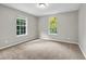 Bedroom with neutral walls and carpet and a large window letting in natural light at 3927 Airline Rd, Mcdonough, GA 30252