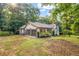 Ranch-style home featuring an attached two-car garage and a spacious, tree-lined backyard at 3927 Airline Rd, Mcdonough, GA 30252