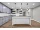 Modern kitchen featuring gray cabinetry, granite countertops, a central island, and stainless steel appliances at 3927 Airline Rd, Mcdonough, GA 30252
