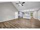 Open-concept living area with wood floors, vaulted ceiling, and a modern kitchen island at 3927 Airline Rd, Mcdonough, GA 30252