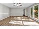 Spacious living area with wood flooring, wainscoting, and a view of the well-landscaped yard at 3927 Airline Rd, Mcdonough, GA 30252