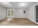 Spacious living room with hardwood floors and a glass patio door to backyard at 3927 Airline Rd, Mcdonough, GA 30252
