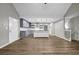 Bright living space featuring wood floors, a modern kitchen, and access to the staircase at 3927 Airline Rd, Mcdonough, GA 30252
