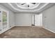 Large main bedroom with tray ceiling, carpet and doors to the outside at 3927 Airline Rd, Mcdonough, GA 30252