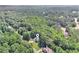 Aerial view of house surrounded by dense forest, highlighting its private and serene location at 7052 Camp Falls Ct, Winston, GA 30187