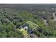 An aerial view of a home and property showing the house surrounded by mature trees at 7052 Camp Falls Ct, Winston, GA 30187