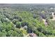 Expansive forest surrounds a well maintained home, visible from an aerial perspective at 7052 Camp Falls Ct, Winston, GA 30187