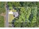 Aerial view of a well-maintained property surrounded by lush greenery and mature trees at 7052 Camp Falls Ct, Winston, GA 30187