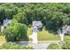 A lovely home nestled amongst dense forest with an expansive lawn and long driveway at 7052 Camp Falls Ct, Winston, GA 30187