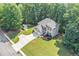 Aerial view showcasing the beautiful home, expansive yard, shed, and surrounding lush greenery at 7052 Camp Falls Ct, Winston, GA 30187