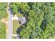 Aerial view showcases the home nestled in a lush forest, offering privacy and tranquility at 7052 Camp Falls Ct, Winston, GA 30187