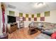 Finished basement with comfortable seating and decorative wall panels at 7052 Camp Falls Ct, Winston, GA 30187