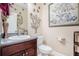 Elegant powder room featuring granite counters and decorative wall art at 7052 Camp Falls Ct, Winston, GA 30187