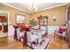 Formal dining room with hardwood floors, elegant seating, and a decorative china cabinet with kitchen access at 7052 Camp Falls Ct, Winston, GA 30187