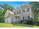 Charming two-story home with a stone facade, three-car garage, and meticulously landscaped front yard at 7052 Camp Falls Ct, Winston, GA 30187
